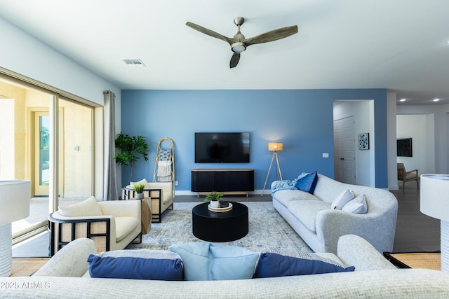 living room featuring baseboards, recessed lighting, a ceiling fan, visible vents, and wood finished floors
