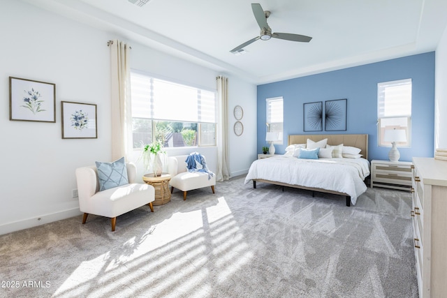 carpeted bedroom featuring visible vents, baseboards, and ceiling fan