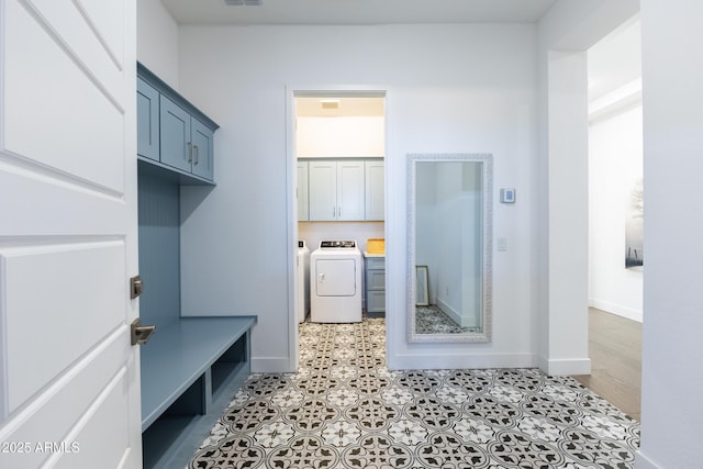 mudroom featuring washer and dryer, visible vents, and baseboards