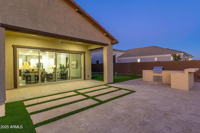 view of patio featuring area for grilling and fence