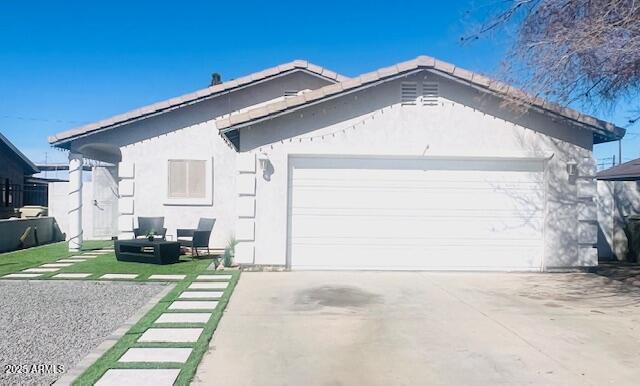 6128 W Palmaire Ave, Glendale, AZ 85301 - view of front of home featuring an attached garage, concrete driveway, and stucco siding