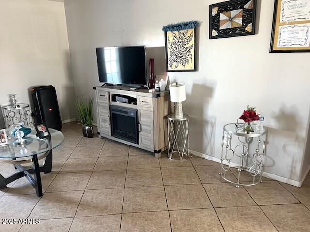 6128 W Palmaire Ave, Glendale, AZ 85301 - living room featuring baseboards and light tile patterned floors