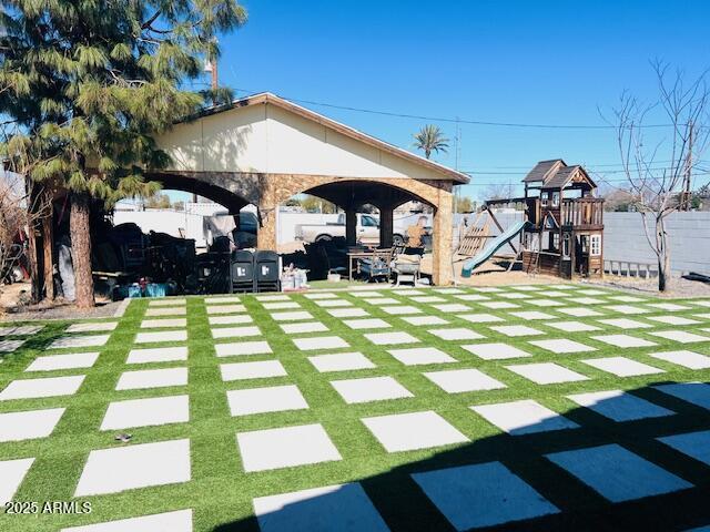 6128 W Palmaire Ave, Glendale, AZ 85301 - view of grassy yard with a playground