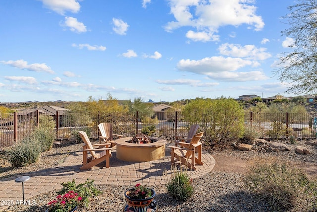 view of yard with a patio, fence, and an outdoor fire pit