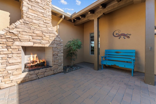 view of patio / terrace with an outdoor stone fireplace