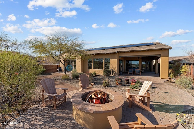 view of patio with a fire pit and fence