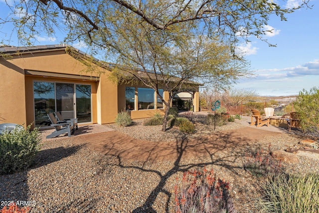 back of house with a patio area and stucco siding