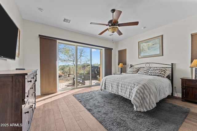 bedroom with ceiling fan, visible vents, light wood-style floors, and access to exterior