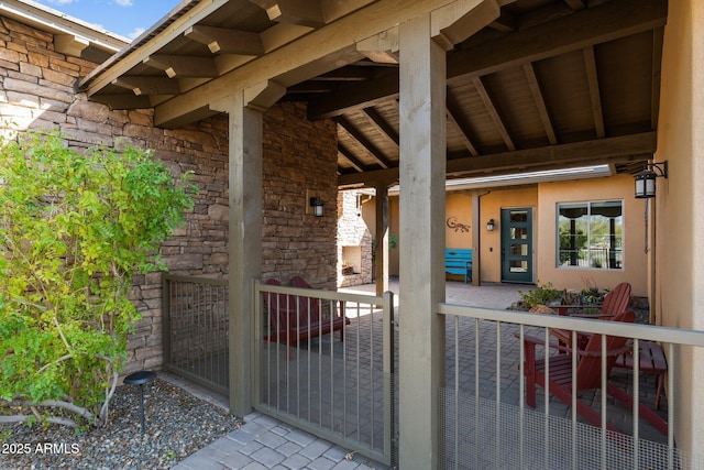 entrance to property with stone siding and stucco siding