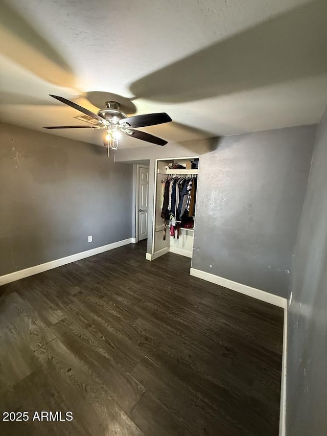 6429 W Palm Ln, Phoenix, AZ 85035 - unfurnished bedroom with dark wood finished floors and ceiling fan