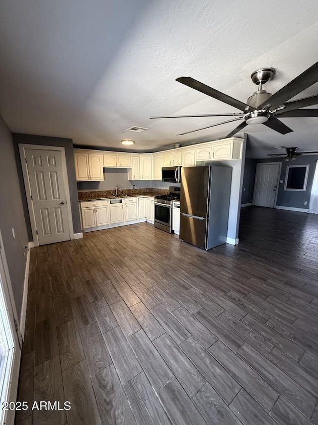 6429 W Palm Ln, Phoenix, AZ 85035 - kitchen with appliances with stainless steel finishes, dark wood finished floors, open floor plan, and dark countertops