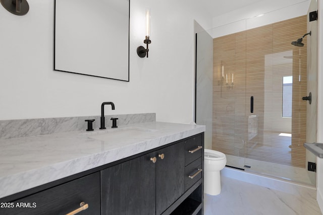 full bath featuring a stall shower, vanity, and toilet