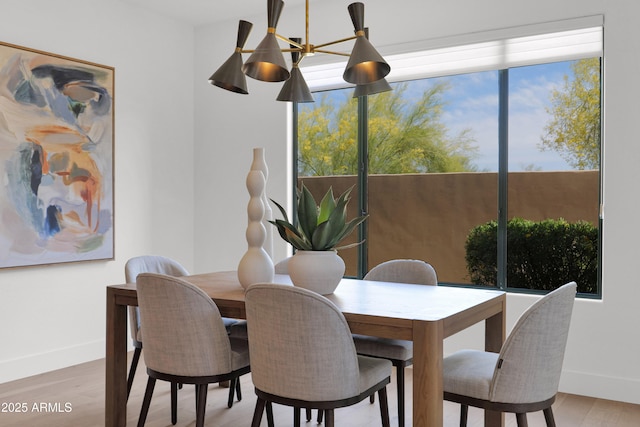 dining area with wood finished floors and baseboards