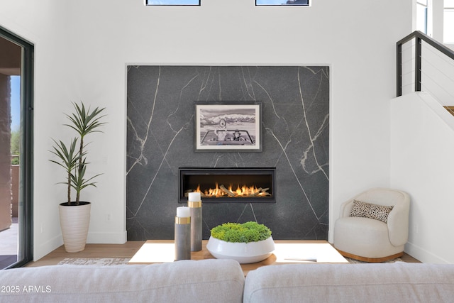 details featuring a fireplace, baseboards, and wood finished floors