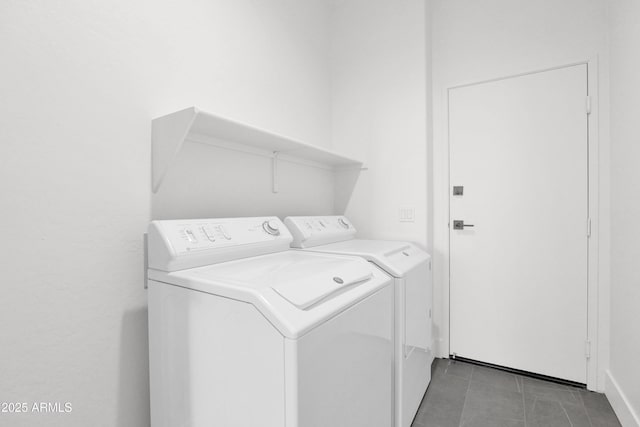 laundry area featuring separate washer and dryer, laundry area, and light tile patterned floors
