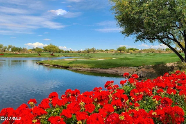 surrounding community featuring a water view, golf course view, and a lawn