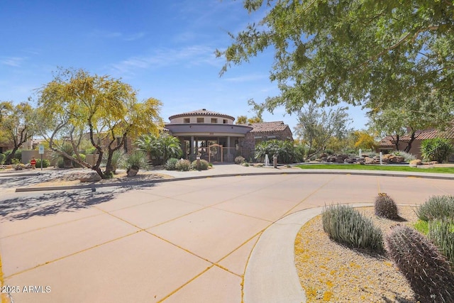 exterior space with a tiled roof and stucco siding