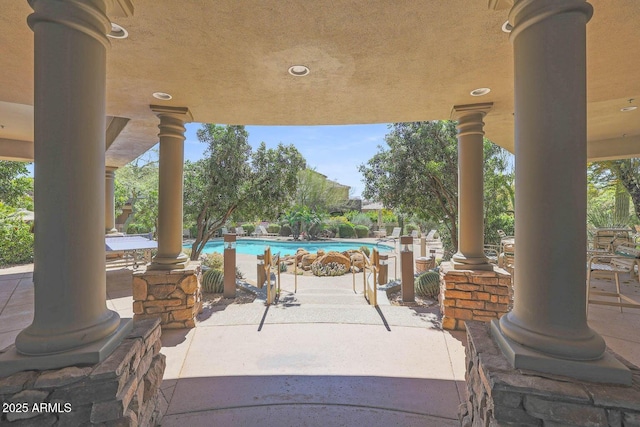 view of patio featuring a community pool