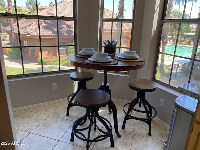dining space featuring plenty of natural light and light tile patterned floors