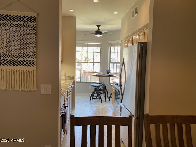 corridor featuring light tile patterned floors and recessed lighting