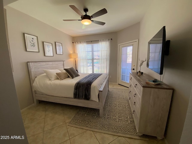 bedroom featuring access to exterior, light tile patterned floors, baseboards, and ceiling fan