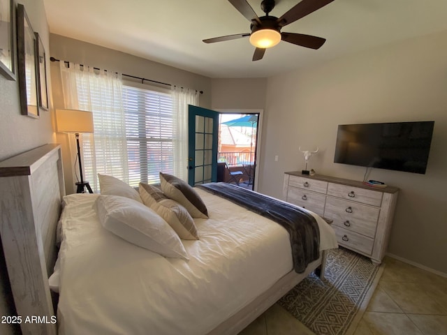 bedroom featuring light tile patterned floors, ceiling fan, and baseboards