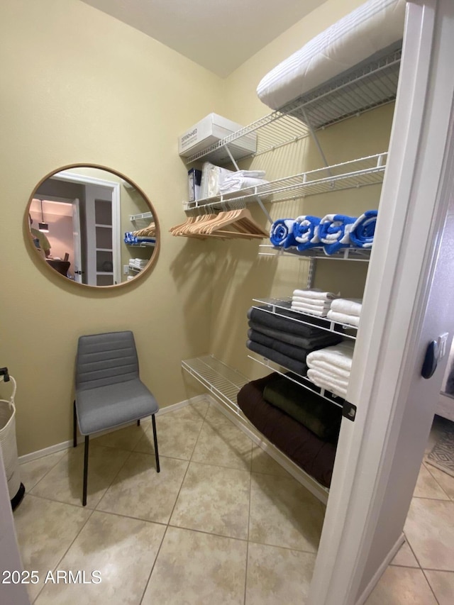 walk in closet with tile patterned flooring