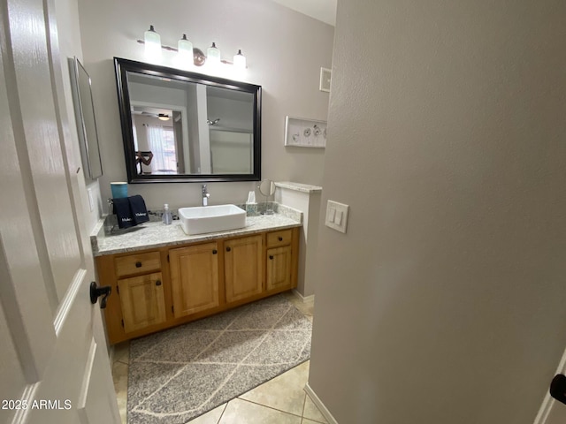 bathroom with tile patterned flooring, vanity, and baseboards
