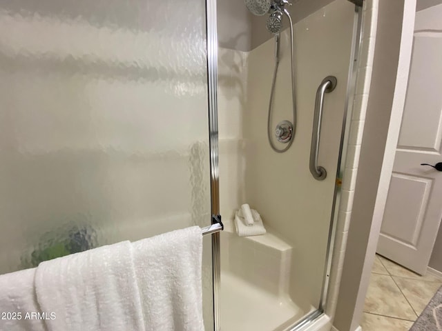 full bathroom featuring a stall shower and tile patterned flooring