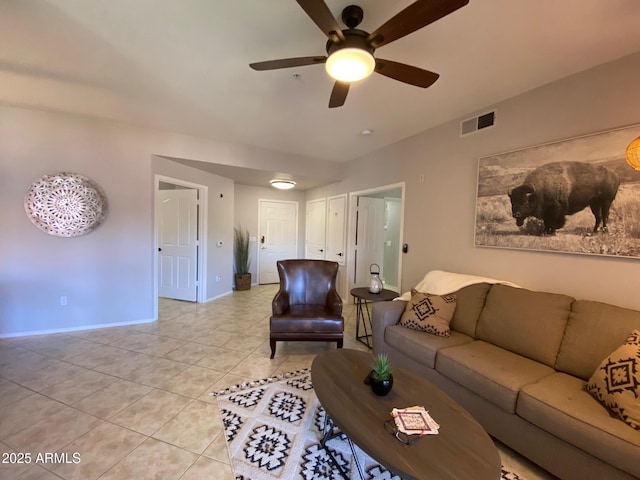 living room featuring ceiling fan, baseboards, and light tile patterned floors