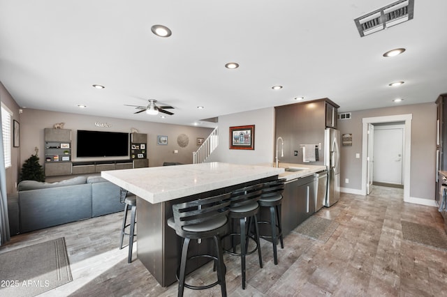23211 N 22nd Pl, Phoenix, AZ 85024 - kitchen featuring a sink, a ceiling fan, a kitchen bar, stainless steel appliances, and visible vents