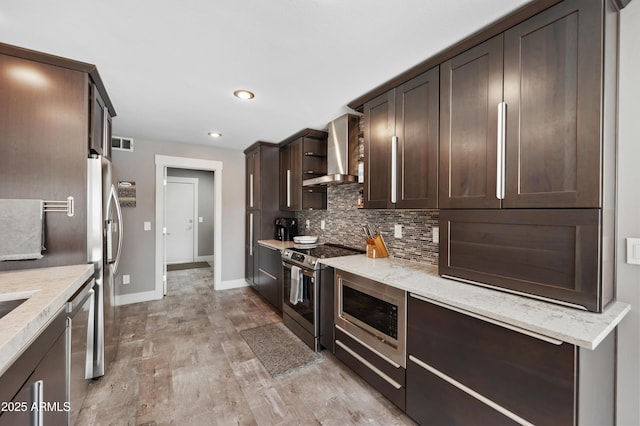 23211 N 22nd Pl, Phoenix, AZ 85024 - kitchen featuring visible vents, stainless steel appliances, dark brown cabinets, tasteful backsplash, and wall chimney range hood