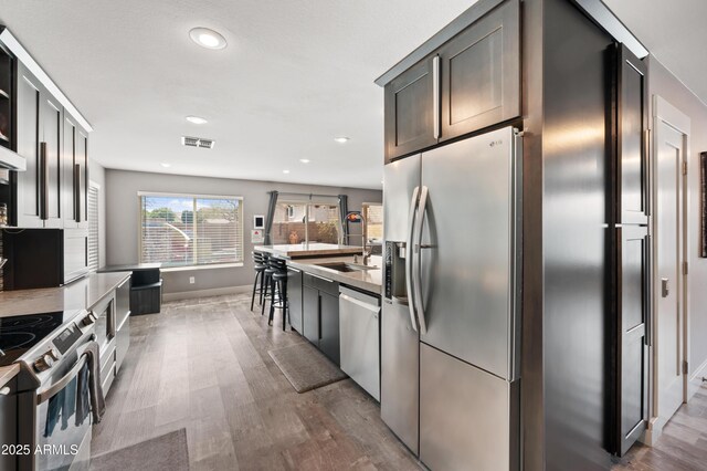 23211 N 22nd Pl, Phoenix, AZ 85024 - kitchen with visible vents, recessed lighting, appliances with stainless steel finishes, dark wood-type flooring, and a sink