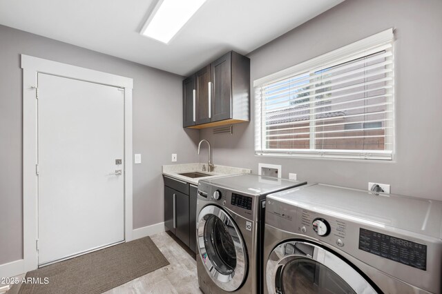23211 N 22nd Pl, Phoenix, AZ 85024 - washroom with a sink, cabinet space, baseboards, and washer and dryer