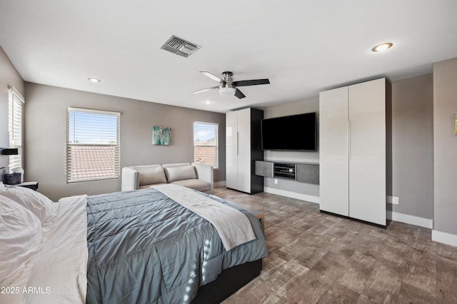 23211 N 22nd Pl, Phoenix, AZ 85024 - bedroom with a ceiling fan, wood finished floors, baseboards, visible vents, and two closets