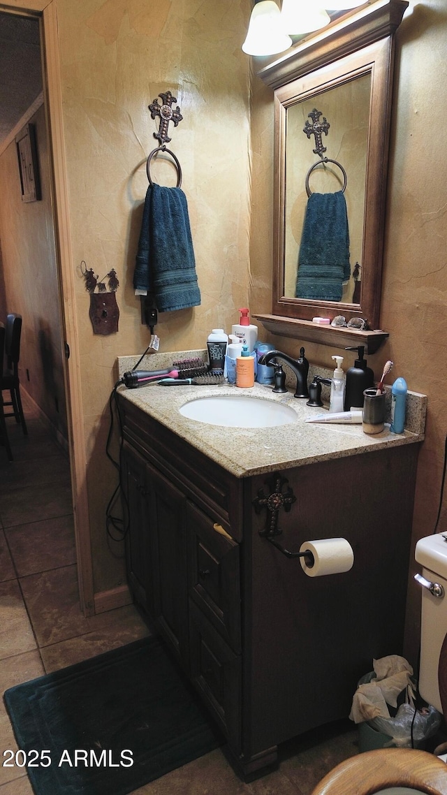 bathroom featuring vanity and toilet