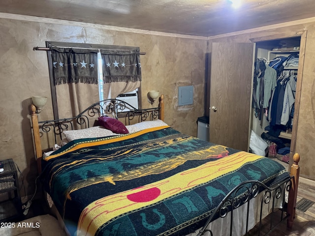 bedroom with a walk in closet, crown molding, visible vents, and a closet