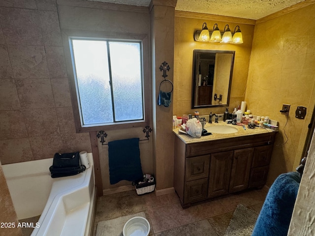 bathroom featuring a wealth of natural light, tile patterned flooring, a textured ceiling, and vanity