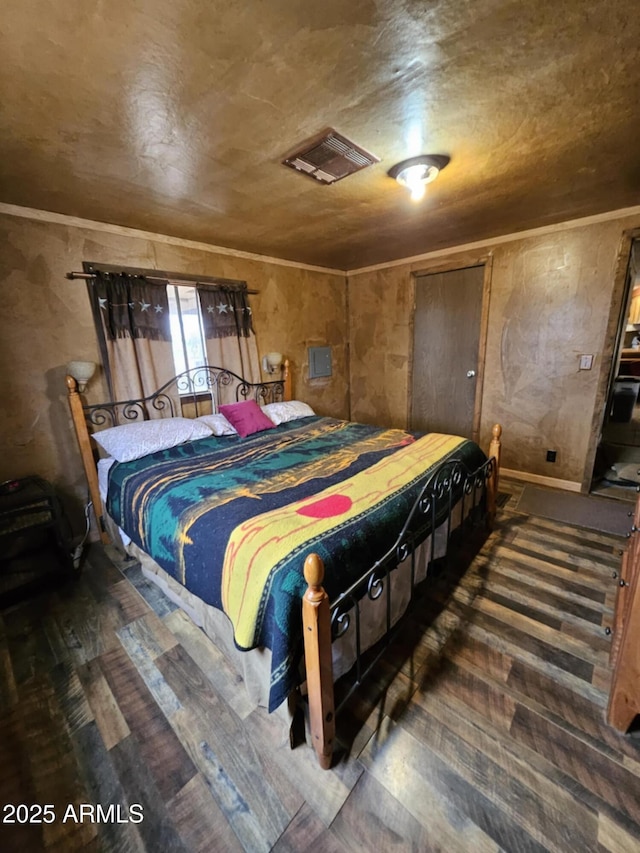 bedroom featuring visible vents, wood finished floors, and crown molding