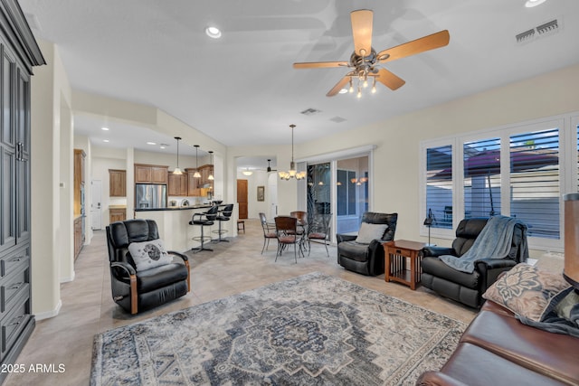 living area featuring ceiling fan with notable chandelier, light tile patterned flooring, visible vents, and recessed lighting