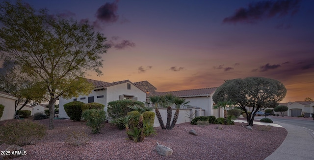 view of front of house featuring a tiled roof and stucco siding