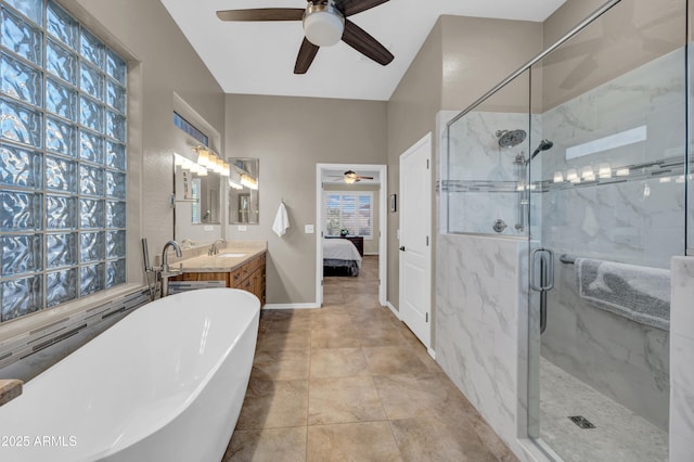 bathroom featuring a freestanding tub, vanity, baseboards, a marble finish shower, and ensuite bath