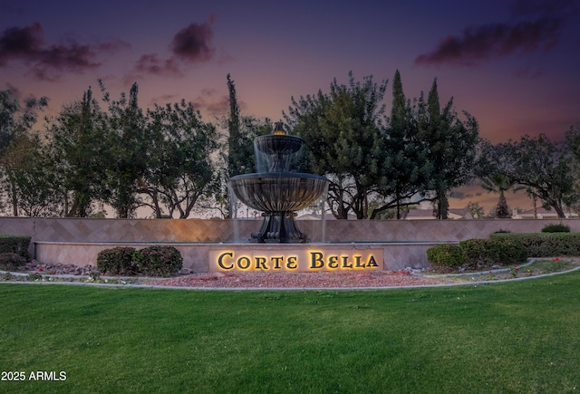 community sign featuring a lawn