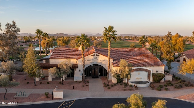 property at dusk with a mountain view