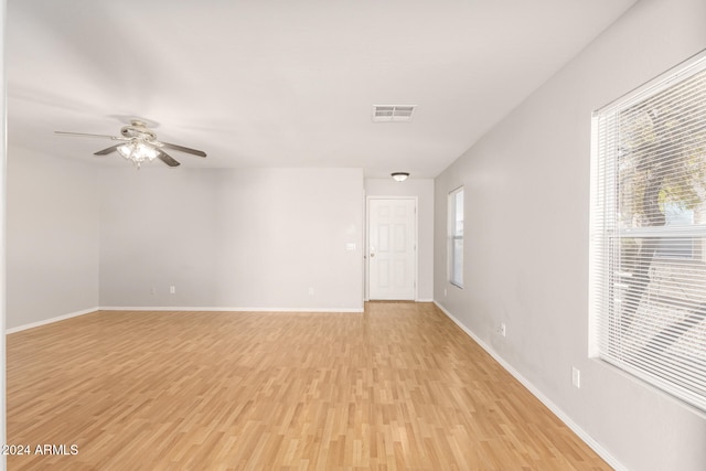 empty room featuring ceiling fan and light wood-type flooring