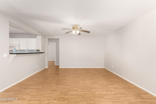 unfurnished room featuring ceiling fan and light wood-type flooring