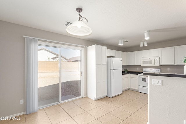 kitchen featuring light tile patterned flooring, white cabinetry, decorative light fixtures, and white appliances