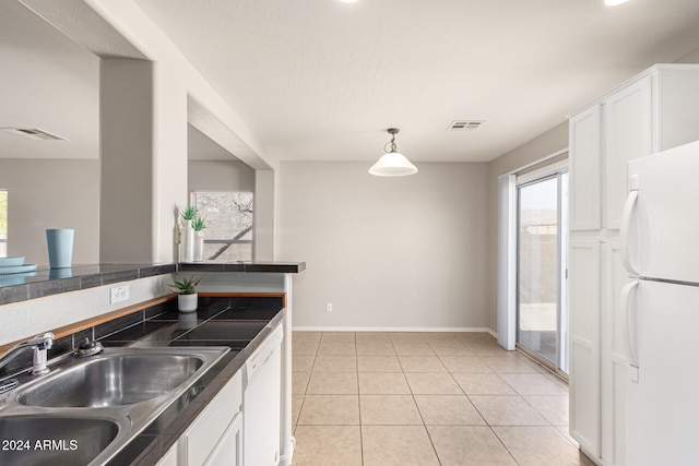 kitchen with white appliances, sink, decorative light fixtures, and white cabinets