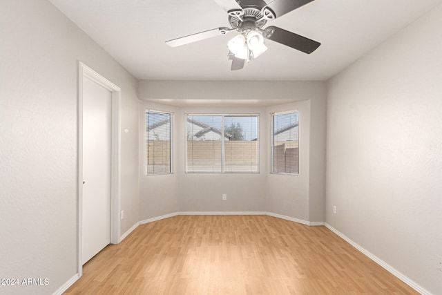 unfurnished room featuring light hardwood / wood-style floors and ceiling fan