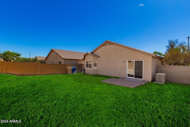 back of house with a yard, a patio, and central air condition unit